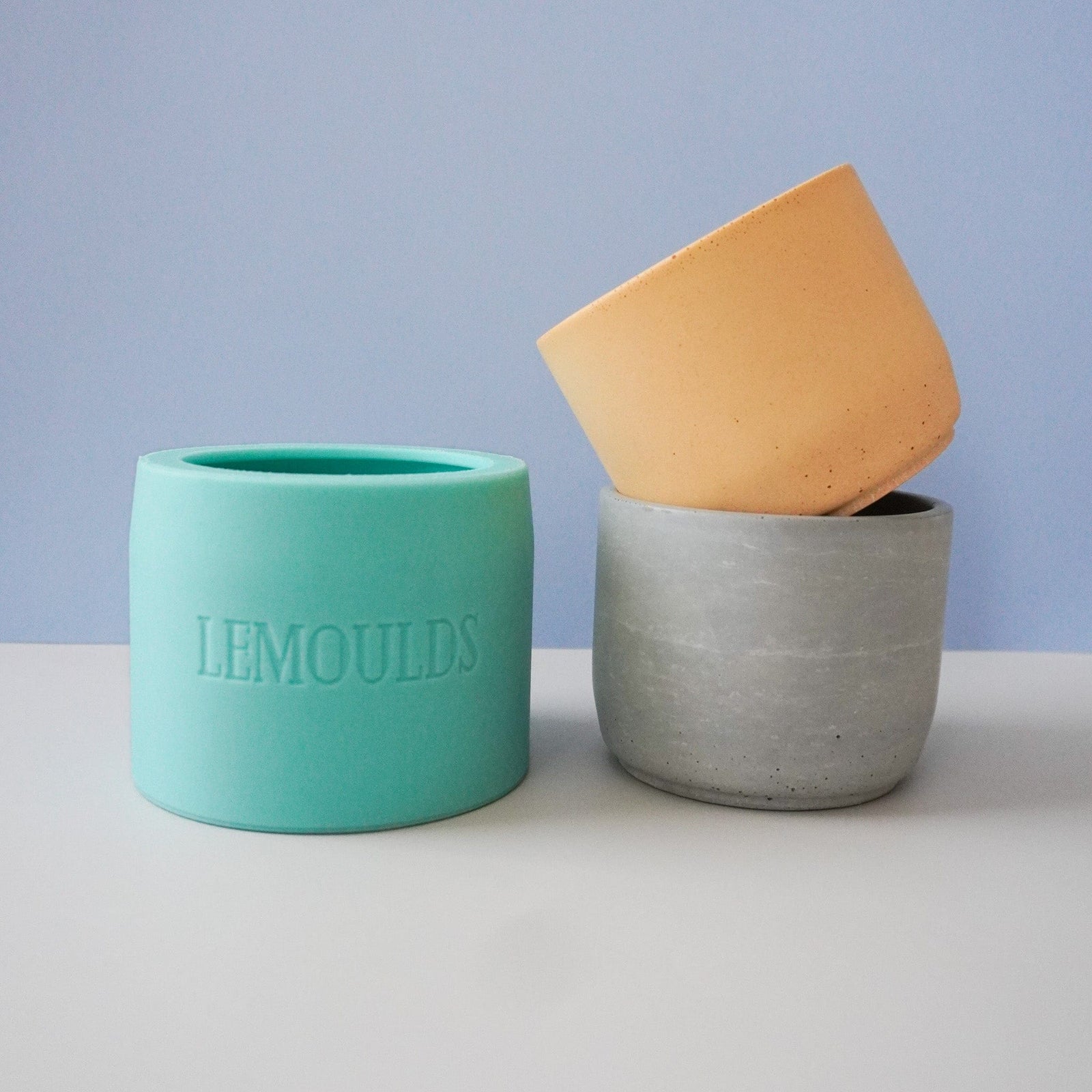 large silicone candle jar mould and two concrete candle jars